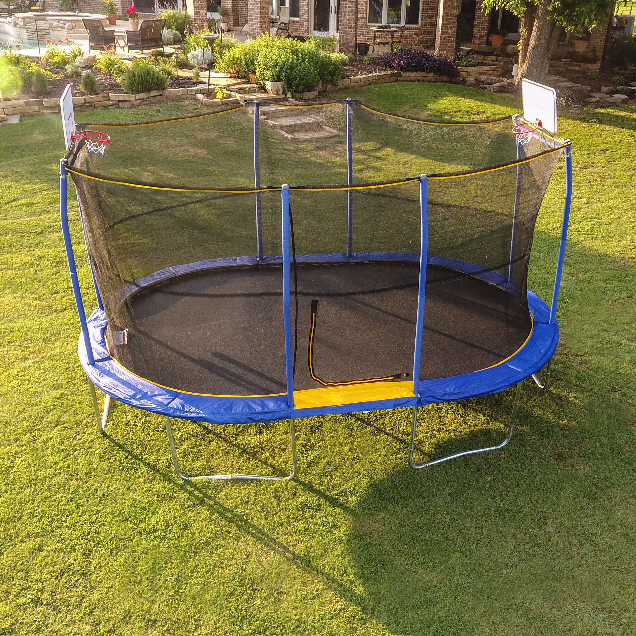 Jumpking Oval 10′ x 15′ Trampoline, with Two Basketball Hoops, Blue/Yellow