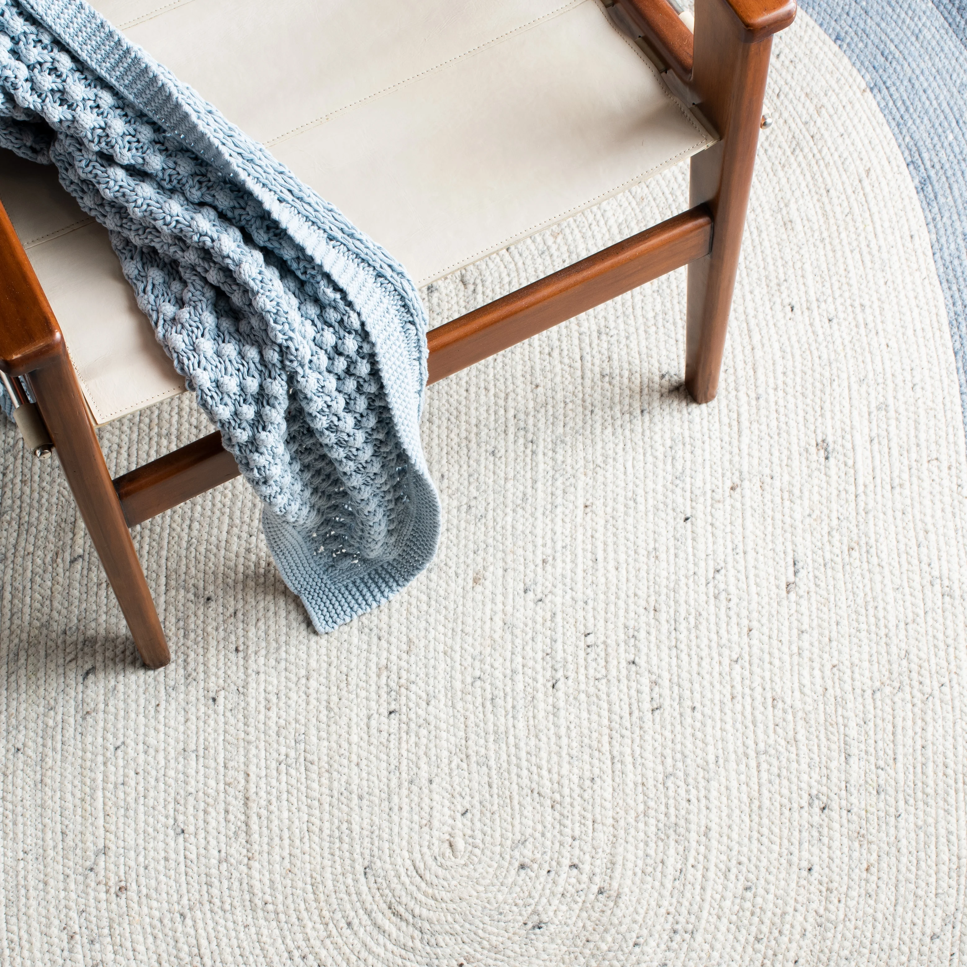 SAFAVIEH Braided Nazca Solid Bordered Area Rug, Ivory/Blue, 4' x 6' Oval